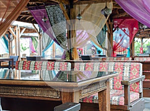 Turkish style design restaurant.  Outside terrace with colourful seats, curtains and mosaic lamps. Selective focus