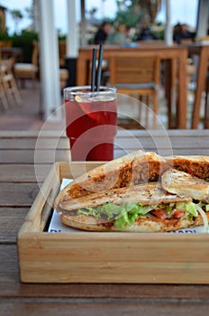 Turkish style fish bread interpretation, fried bread inside, sea bass fish and its accompanying sauce, lettuce, tomato, cucumber