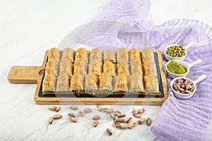 Turkish style pistachio baklava presentation and service. Baklava on a marble floor photo