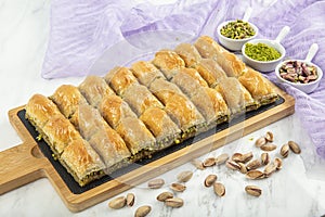 Turkish style pistachio baklava presentation and service. Baklava on a marble floor photo