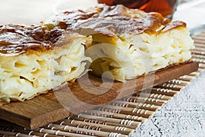 Turkish su boregi, burek or borek, turkish water patty slices with cheese and turkish tea