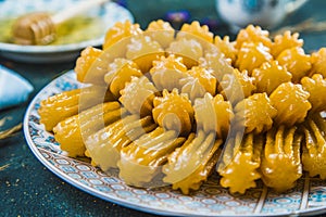 Turkish syrupy dessert tulumba arranged in plate