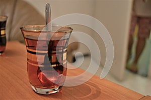 Turkish tea in traditional glasse pot and teaspoon