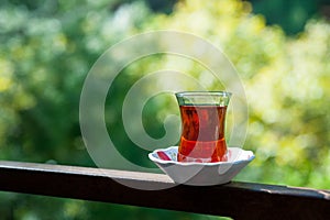 Turkish tea on wheathered wooden board in a garden