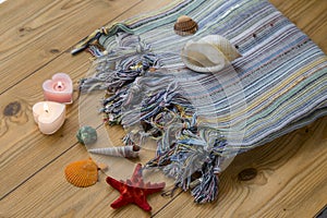 Turkish towel peshtemal with seashells, sea star, and candles