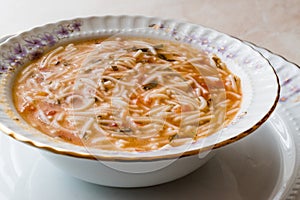 Turkish Traditional Vermicelli Soup in a wooden bowl / Tel sehriye corbasi.