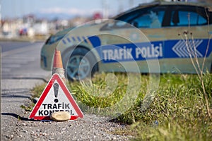 Turkish trafik kontrol sign in front of a fake police car. Trafik kontrol means traffic control photo