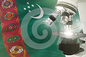 Turkmenistan science development concept - microscope on flag background. Research in medicine or biotechnology 3D illustration of