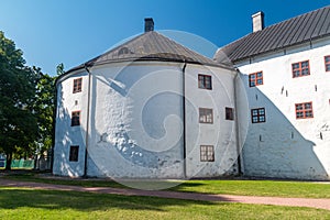 Turku Castle`s bailey. Round brick tower and wall of the historic medieval Turku castle in Finland