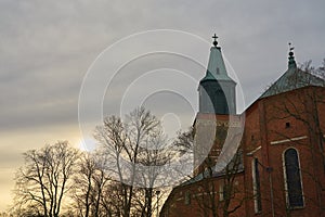 Turku Cathedral behind trees on a sunset