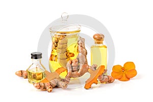 Turmeric or curcuma longa rhizome and oil isolated white background