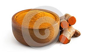 Turmeric curcumin powder in a wooden bowl  and rhizomes  isolated on a white background,herbal