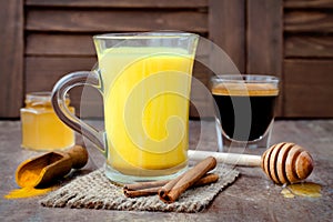 Turmeric golden milk latte with cinnamon sticks and honey. Detox liver fat burner, immune boosting, anti inflammatory drink