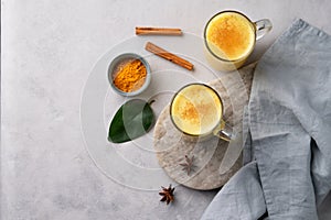 Turmeric golden milk latte with spices and honey. Detox, immunity boosting, anti-inflammatory, healthy, cozy drink in a glass cup