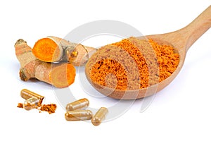 Turmeric ground in wooden spoon with curcuma root and turmeric powder capsules isolated on white  background.