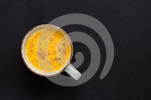 Turmeric latte with milk and cinnamon. Elixir of health and vivacity. Traditional healthy Indian detox drink