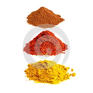 Turmeric, paprika, cinnamon powders on white