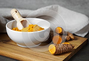 Turmeric Powder Bowl And Sliced Turmeric Roots