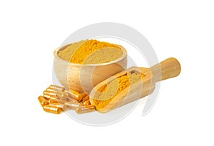 Turmeric powder and capsules  on white background
