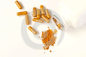 Turmeric powder and capsules on white background with copy space, herbal medicine curcumin or curcuma for good health