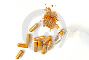 Turmeric powder and capsules on white background with copy space, herbal medicine curcumin or curcuma for good health