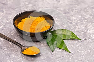 Turmeric powder close up on a grunge cooking table