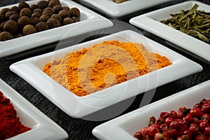 Turmeric powder. Colorful spices in white bowls Seasonings for cooking.