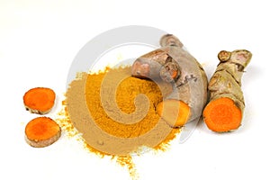 Turmeric powder and fresh turmeric roots isolated on a white background