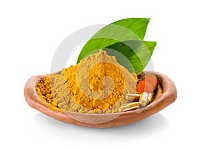 Turmeric powder and turmeric capsules on white background