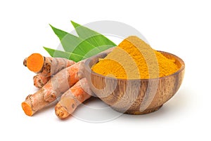 Turmeric powder in a wooden bowl and turmeric (curcumin) rhizomes isolated on a white background.