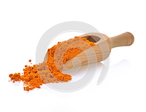 Turmeric powder on a wooden spoon isolated on white background. photo