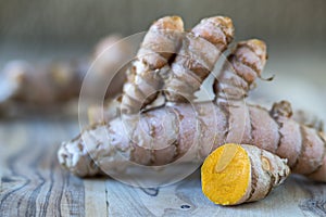 Turmeric rhizomes on a wooden plate photo