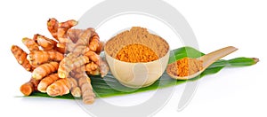 Turmeric root and dry tumeric in wood bowl