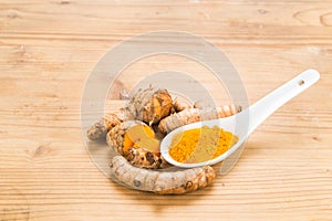 Turmeric roots and powder, healthy food with healing properties.