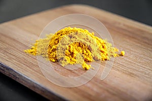 Turmeric spice powder on a cutting board