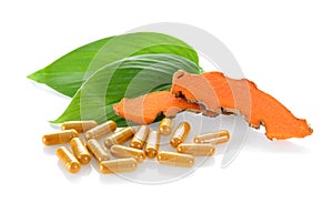 Turmeric and turmeric capsules on white background