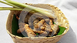 Turmeric & x28;kunyit& x29;, ginger & x28;jahe& x29;, lemongrass & x28;sereh& x29; on a besek with green banana leaves photo