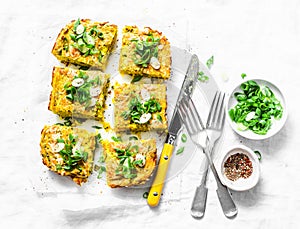 Turmeric, zucchini, mashed chickpeas tortilla with herbs on a light background, top view. Delicious appetizers