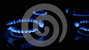 Turn on Gas Burners, Blazing with a Blue Flame, at Night in Kitchen. Close-Up