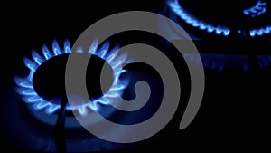 Turn on Gas Burners, Blazing with a Blue Flame, at Night in Kitchen. Close-Up