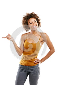 Turn haters into motivators. Studio shot of an attractive young woman pointing towards something.