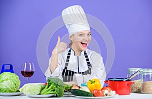 Turn ingredients into delicious meal. Culinary skills. Woman chef wear hat apron near table ingredients. Girl adorable
