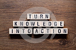 Turn knowledge into action - word concept on building blocks, text