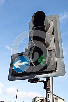 Turn left green arrow traffic sign lit up indicating to safe to proceed