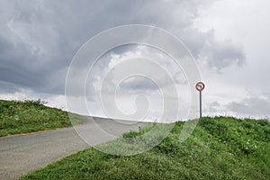 Turn left prohibited sign in surrealistic and desolate landscape