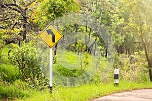 Turn left sign on the way between hill in Thailand.