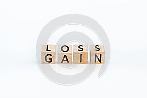 turn loss into gain concept, wooden cube with word LOSS flip to GAIN. capital investment gain and loss, financial while managing