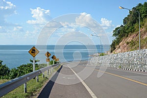 Turn of mountain road with blue sky and sea