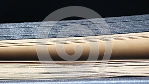 Turn over pages of a notebook with black and brown pages, macro