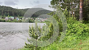 The turn of the river against the backdrop of mountains and forest